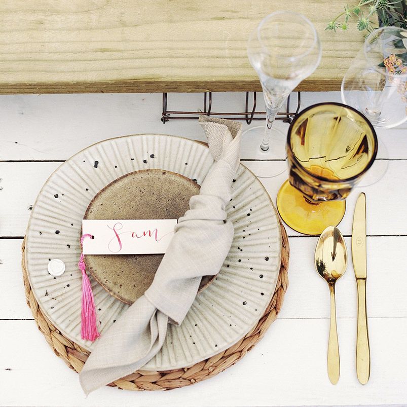 Neutral wedding place setting with gold cutlery 
