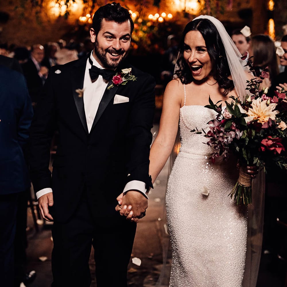 A happy and exciting moment for the bride and groom as they exit their ceremony as a married couple to confetti