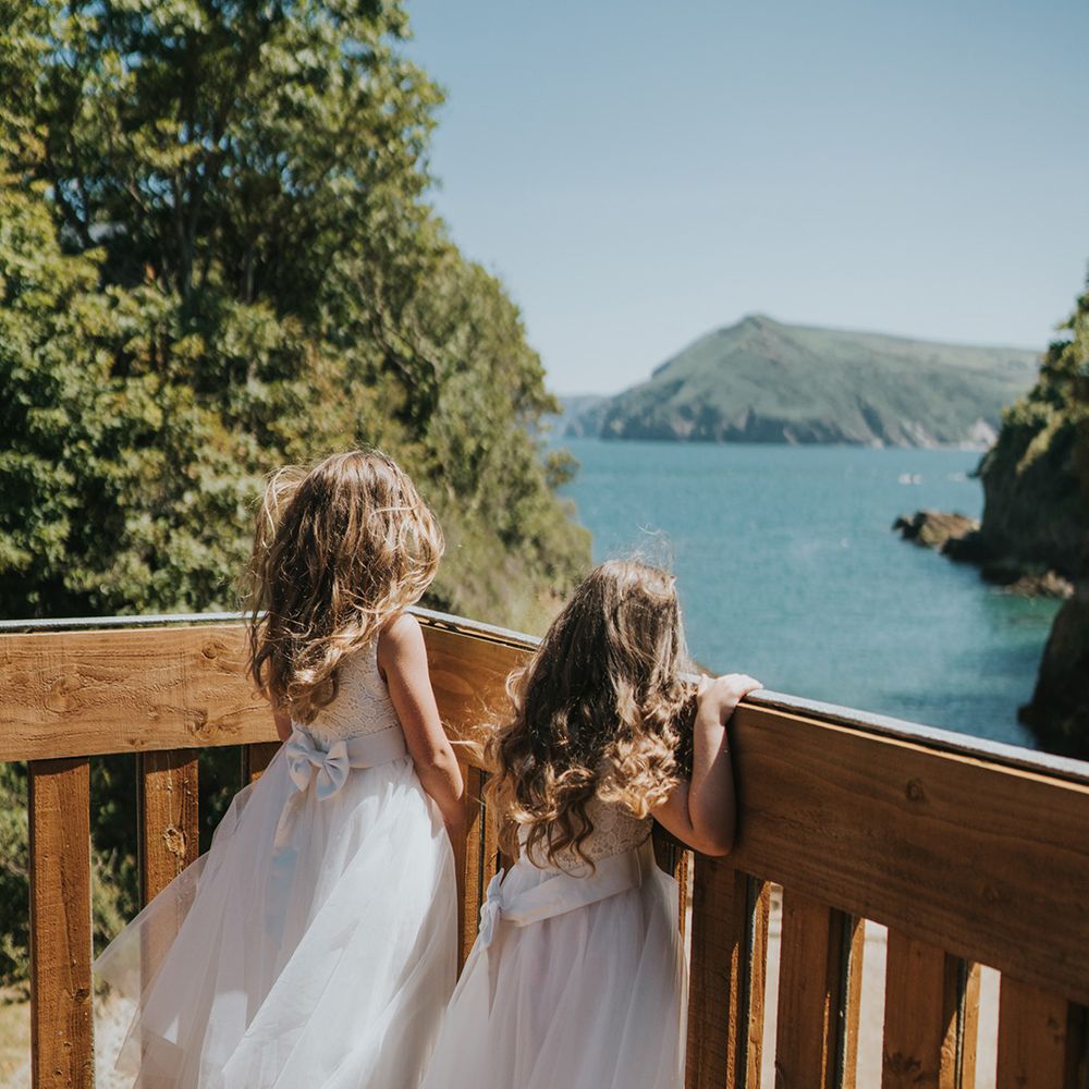 Flower girls wear matching dresses with bows to back and princess skirt 
