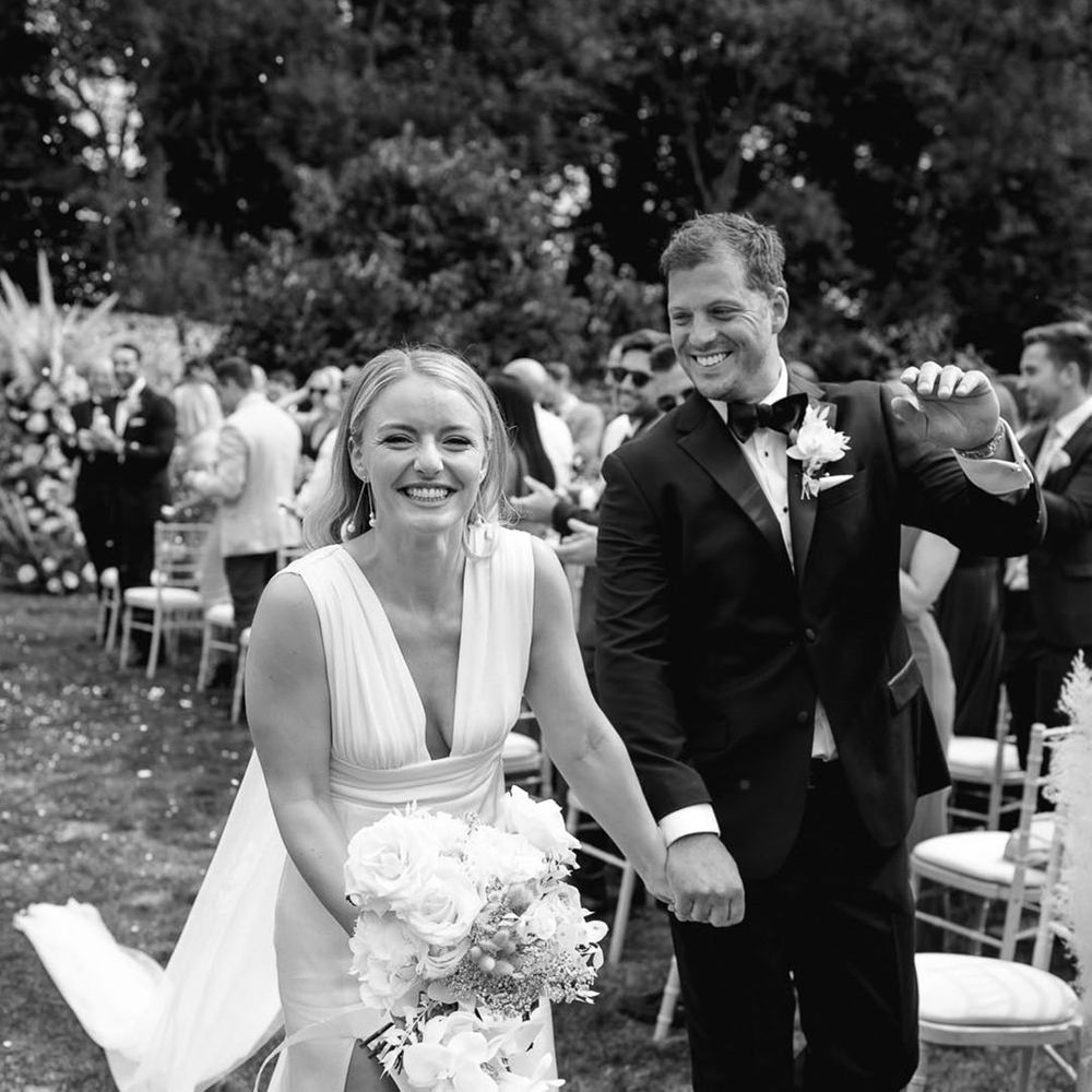 The bride and groom can't stop smiling as they walk back down the aisle at Pythouse Kitchen Gardens 