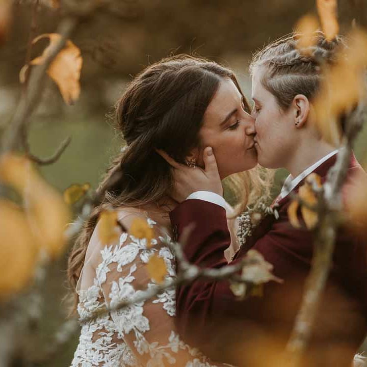 Brides at LGBTQ+ boho wedding doing couples portraits at Bassmead Manor Barns wedding venue Cambridgeshire 