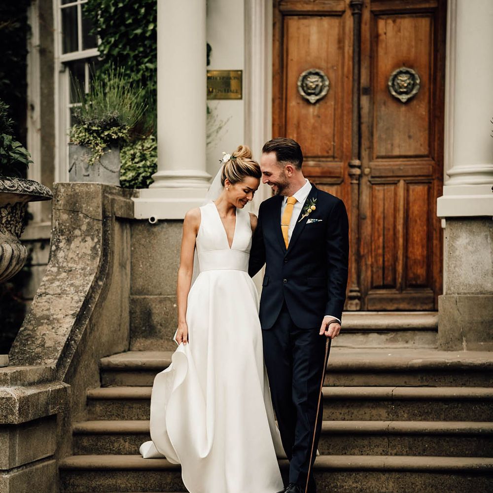 Bride and groom with their pet sausage dog at their Surrey wedding 