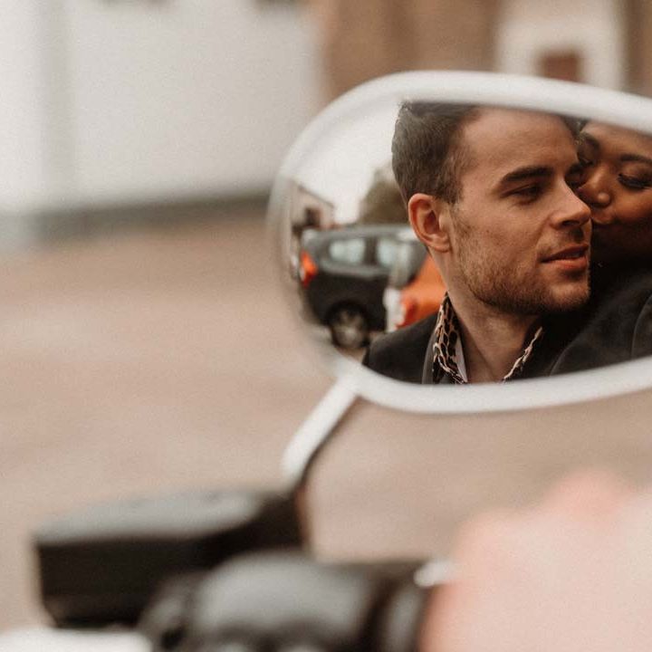 Bride and groom in the mirror of wedding motorbike at German editorial shoot with vinyl wedding arch