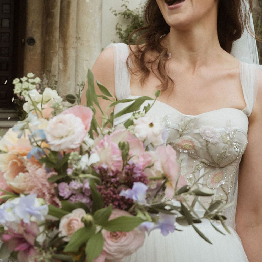 Bride in corset sequin flower custom wedding dress with pastel wedding bouquet 