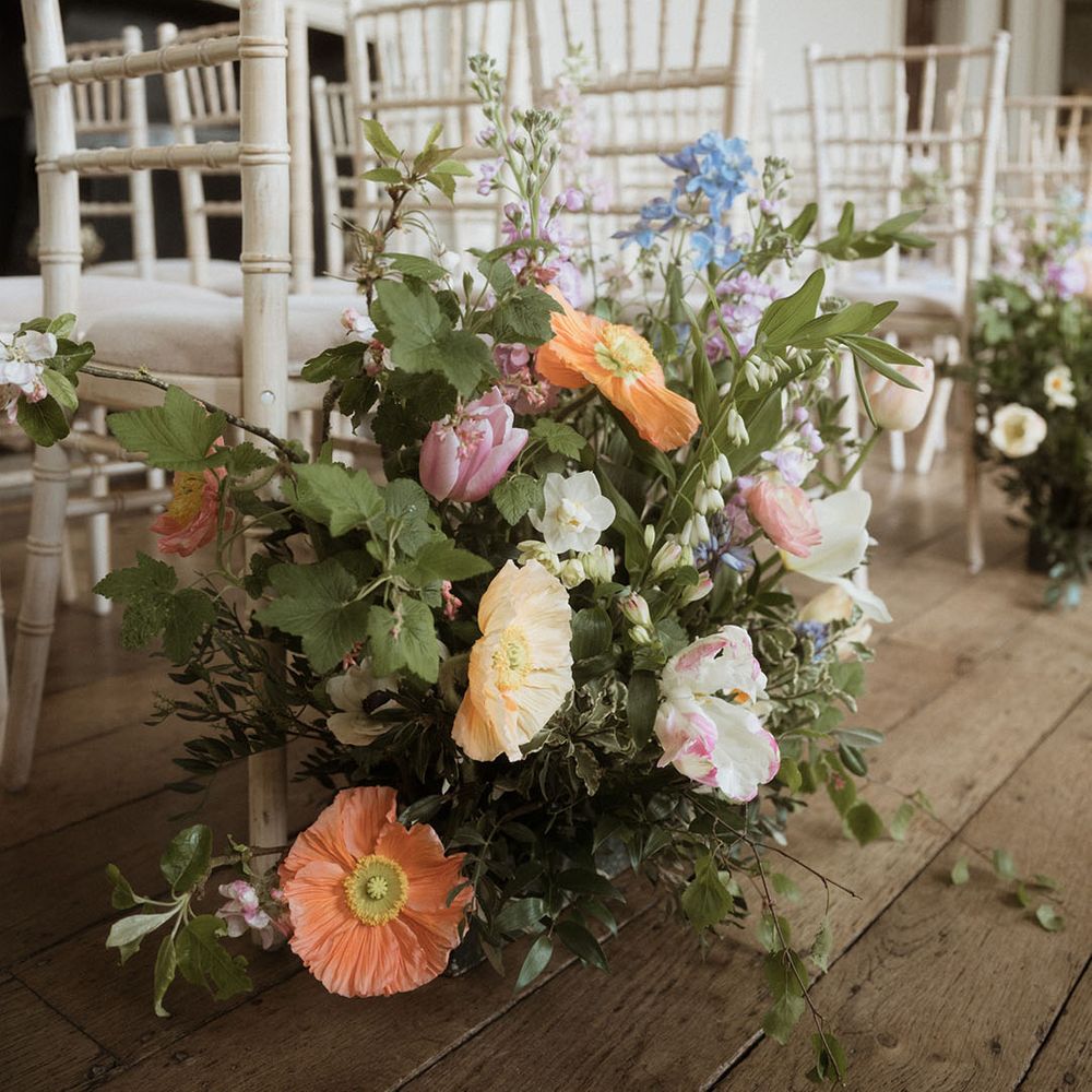 Pastel icelandic poppy in aisle flower arrangements for country house wedding 