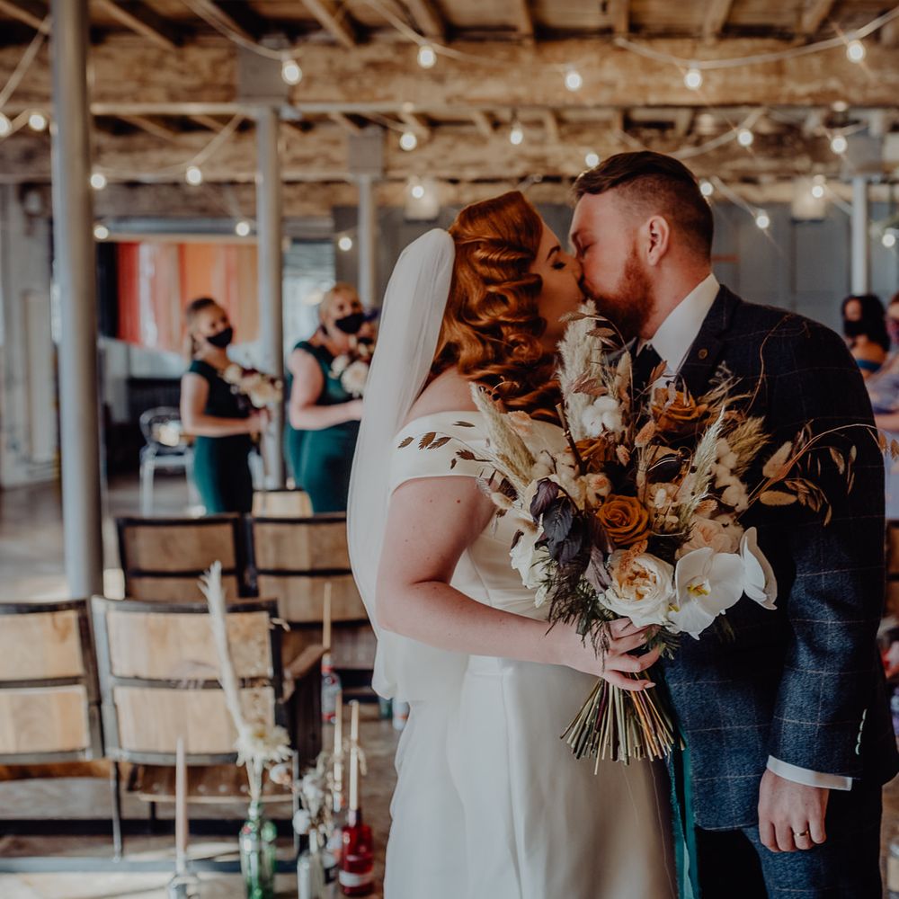 Bride and groom kissing at Holmes Mill, Clitheroe micro wedding
