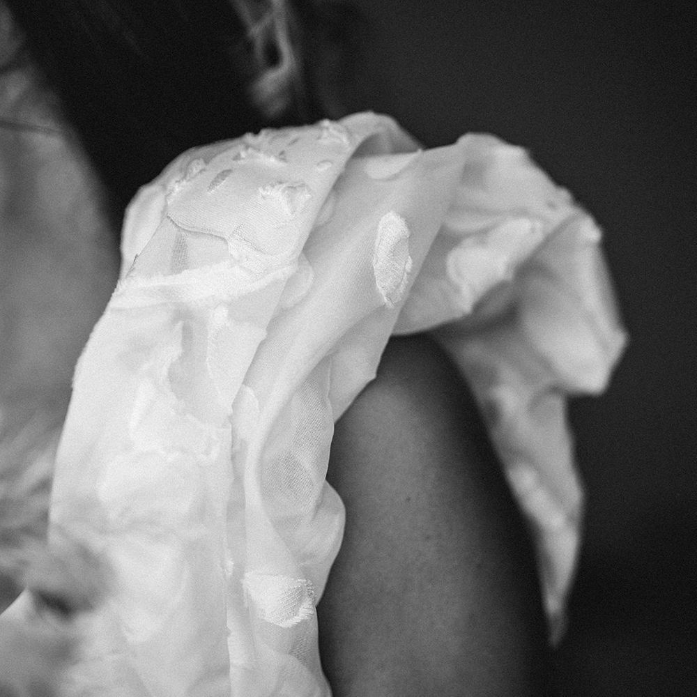 Pattern detail on a Rime Arodaky ruffle sleeve wedding dress