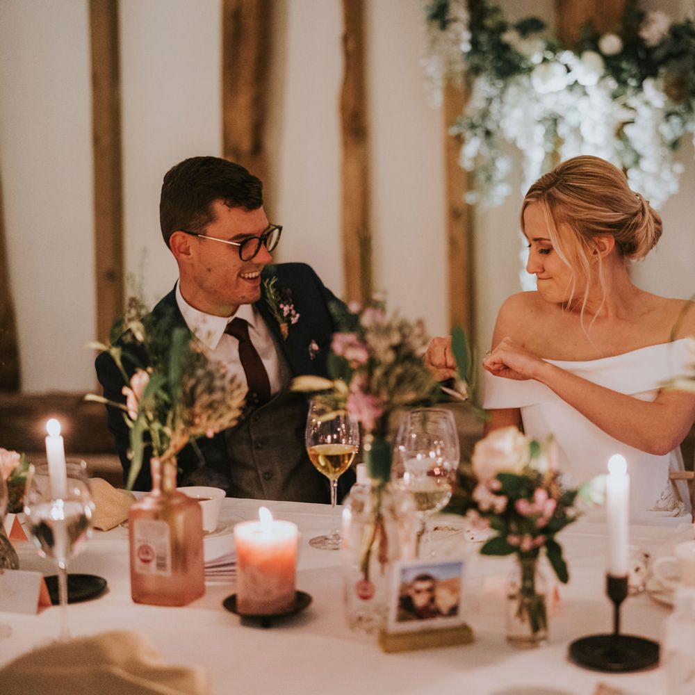 Bride & groom fist bump during wedding reception