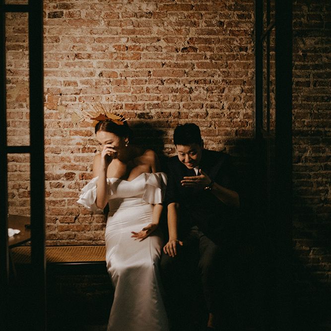 Asian Lesbian wedding portraits with brides laughing in the shadows 