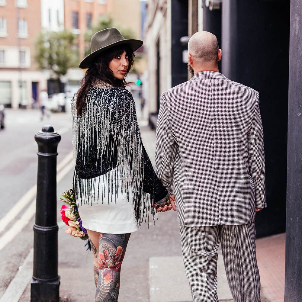 Bride in a tassel wedding jacket and short wedding dress 