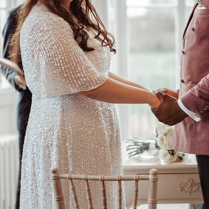 Bride & groom hold hands on their wedding day
