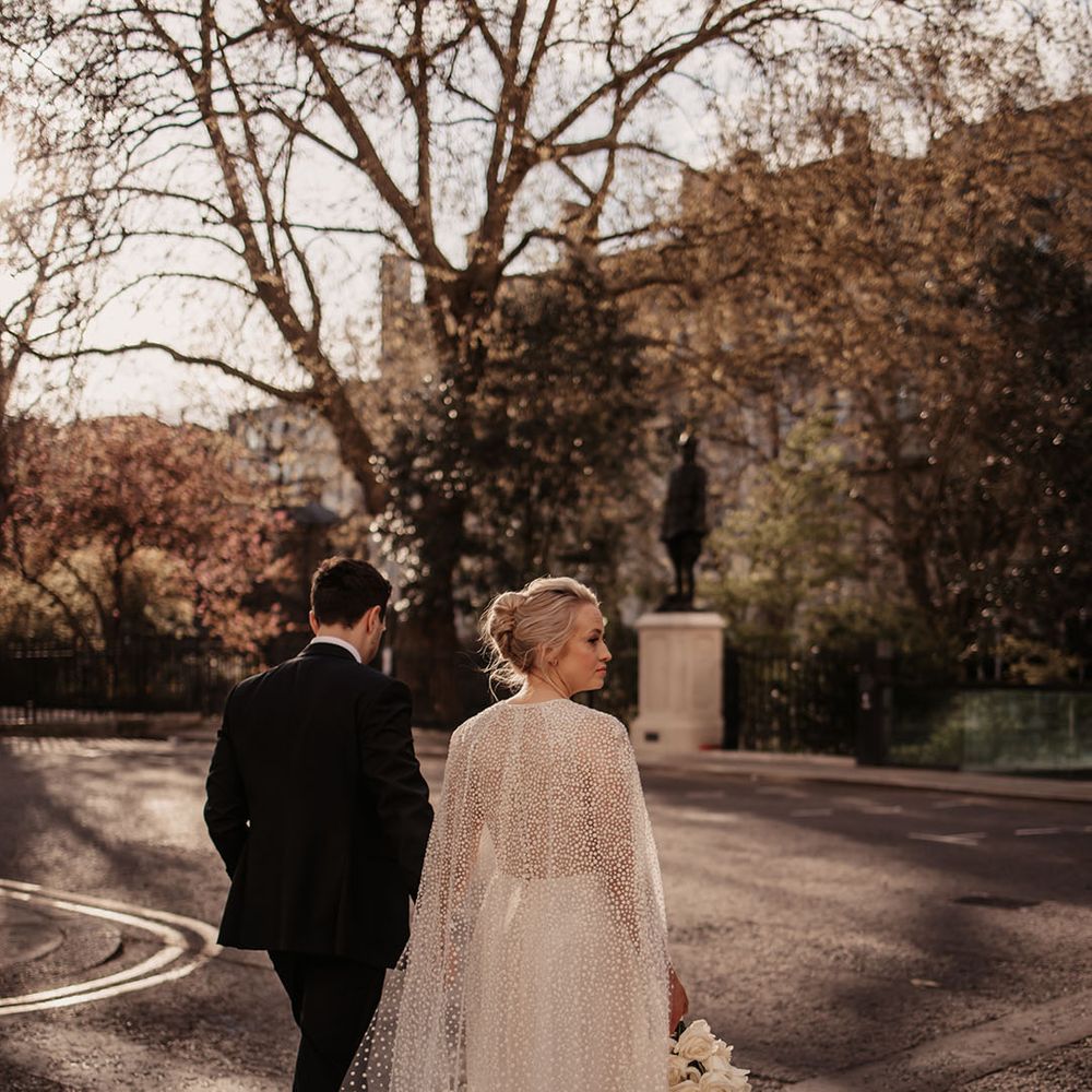 Stylish London city hotel wedding with bride and groom walking around together 