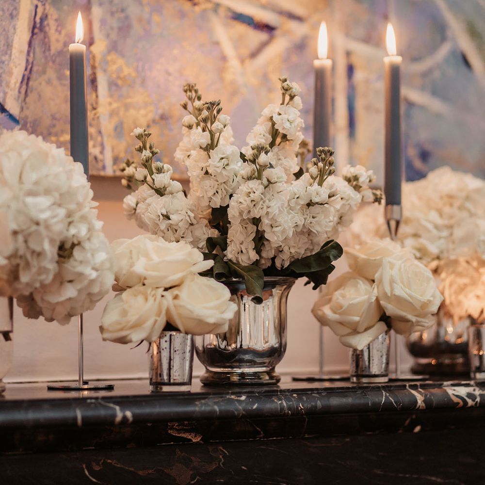 Blue taper candles and white flowers wedding decor 