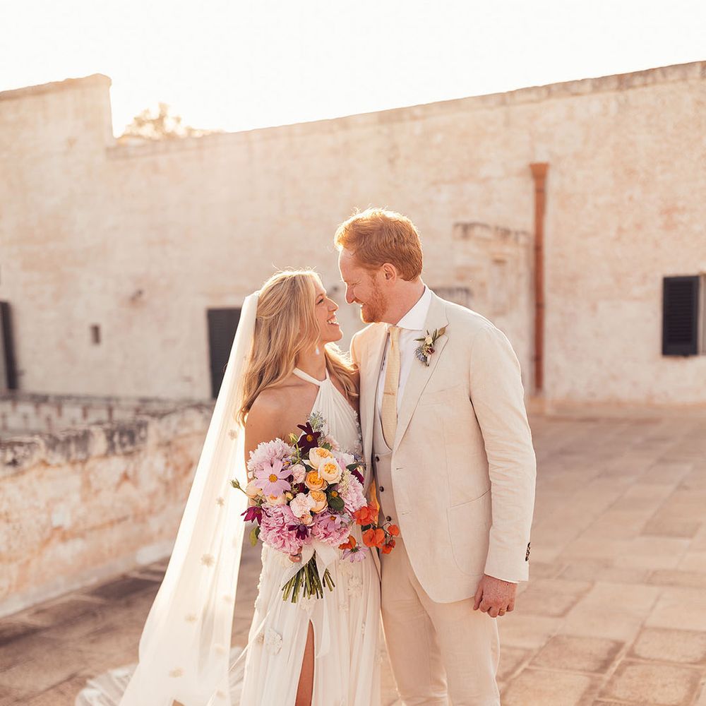Bride and groom smile and look into each other's eyes for their relaxed rustic wedding in Italy 