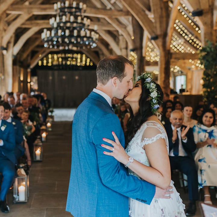 You may now kiss the bride wedding ceremony moment with Indian bride in a floral Savin London Amelia dress