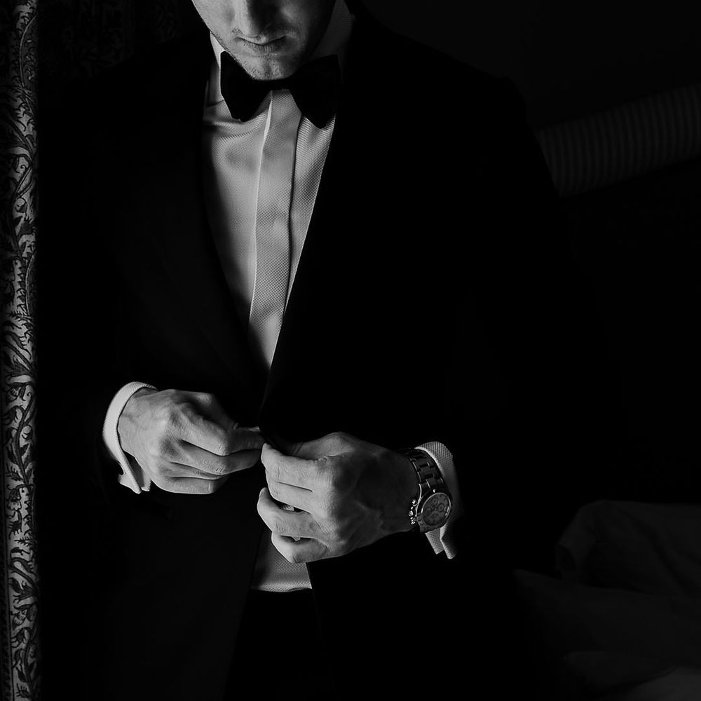 Groom in black and white tuxedo suit for black tie wedding 