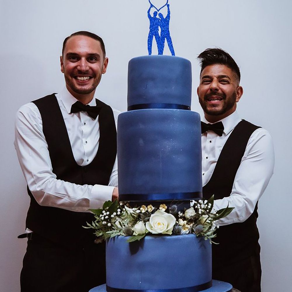 Blue wedding theme at LGBTQI wedding with blue iced wedding cake and blue cake topper 