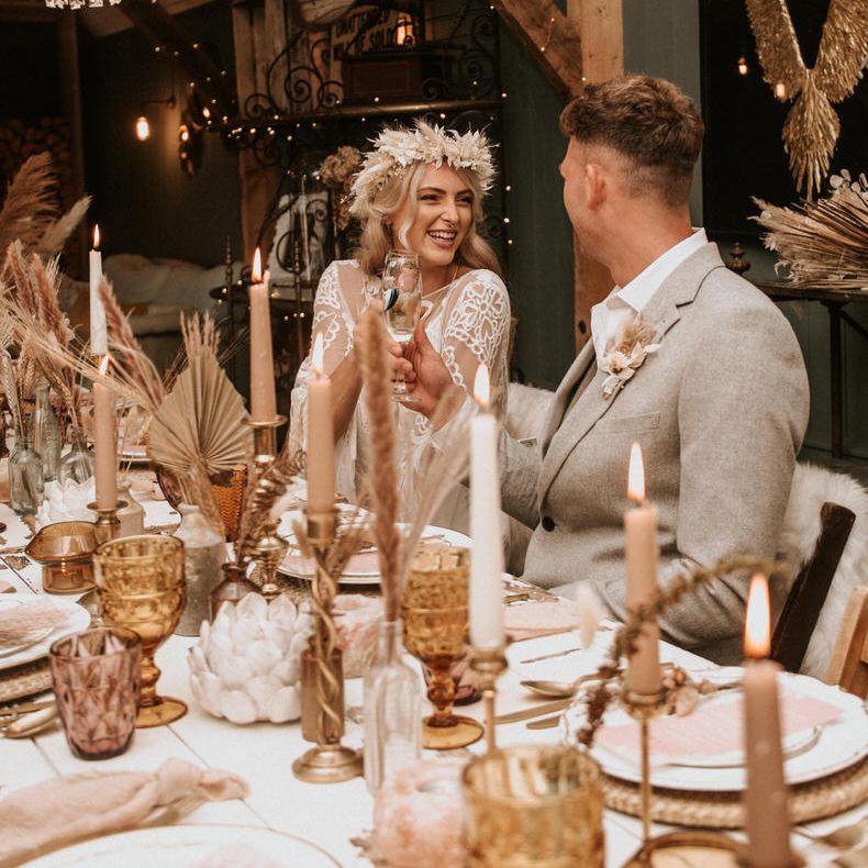 The groom wears a Slater menswear suit for a boho wedding