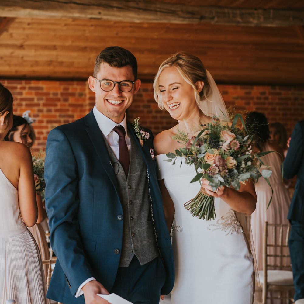 Bride & groom smile and laugh during wedding ceremony