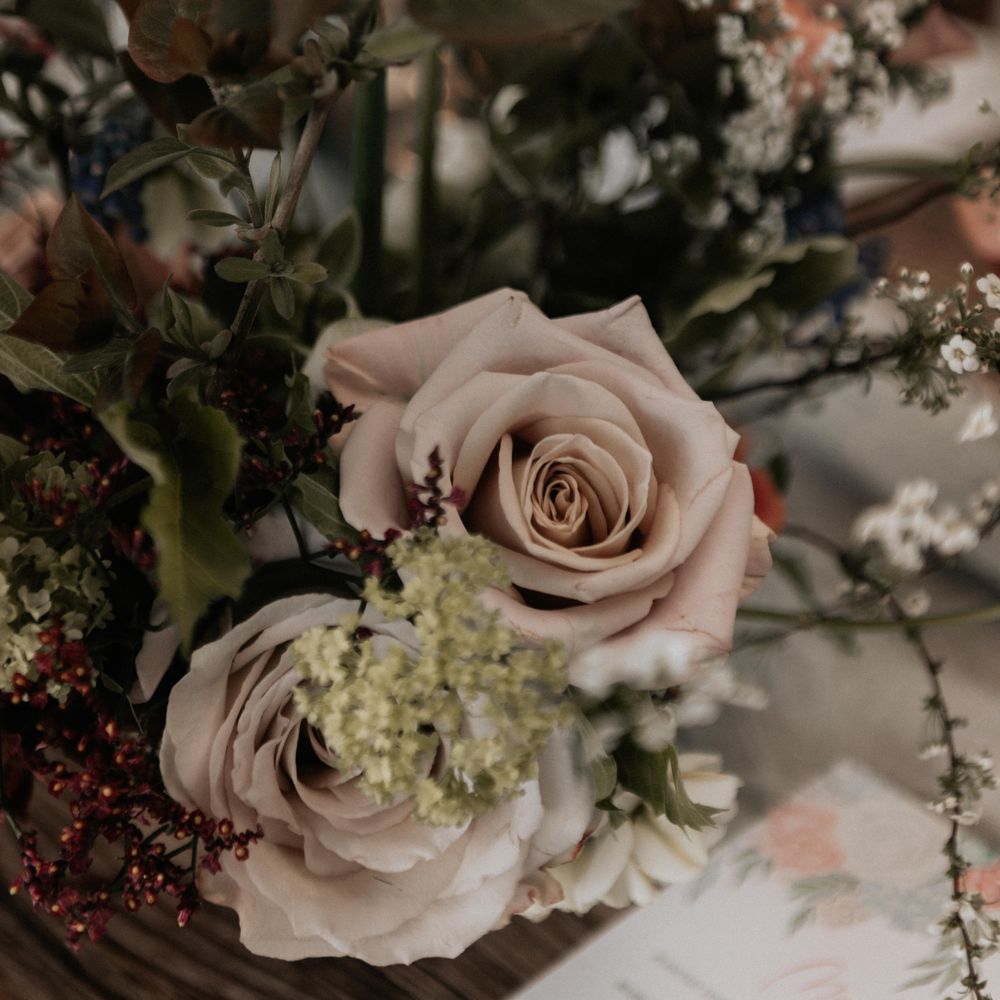Rustic floral bouquet with roses and green foliage