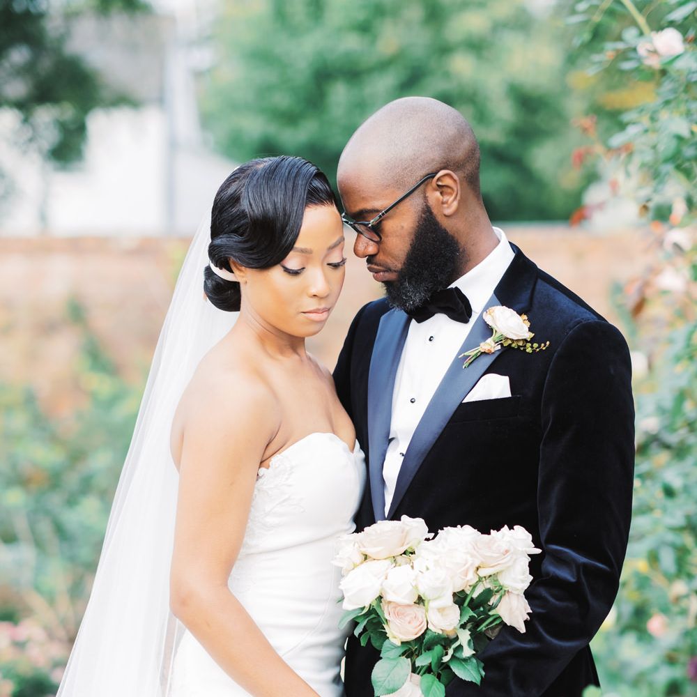 Black bride and Black groom stand together for couple portrait - Classic wedding photographer