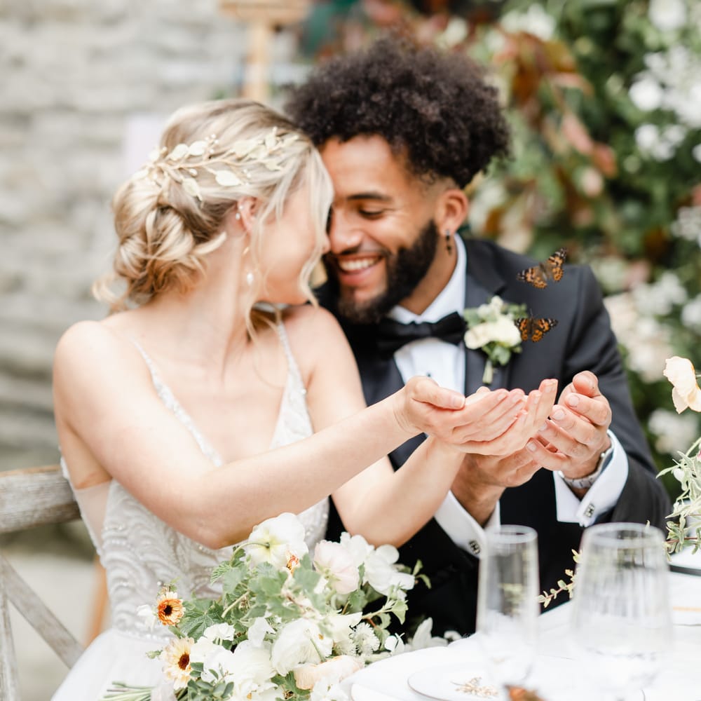 Bride and groom releasing butterflies 