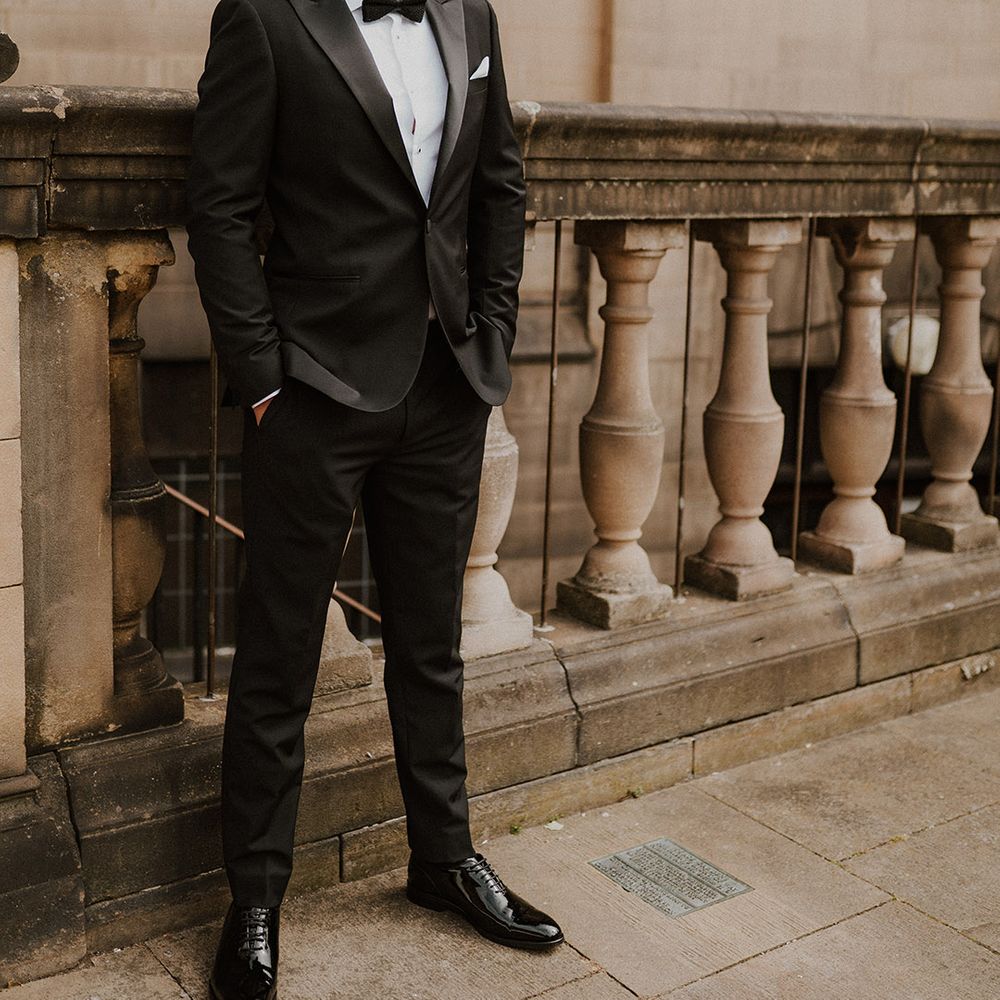 Stylish groom in a Reiss tuxedo with bow tie at intimate Sheffield registry office wedding 