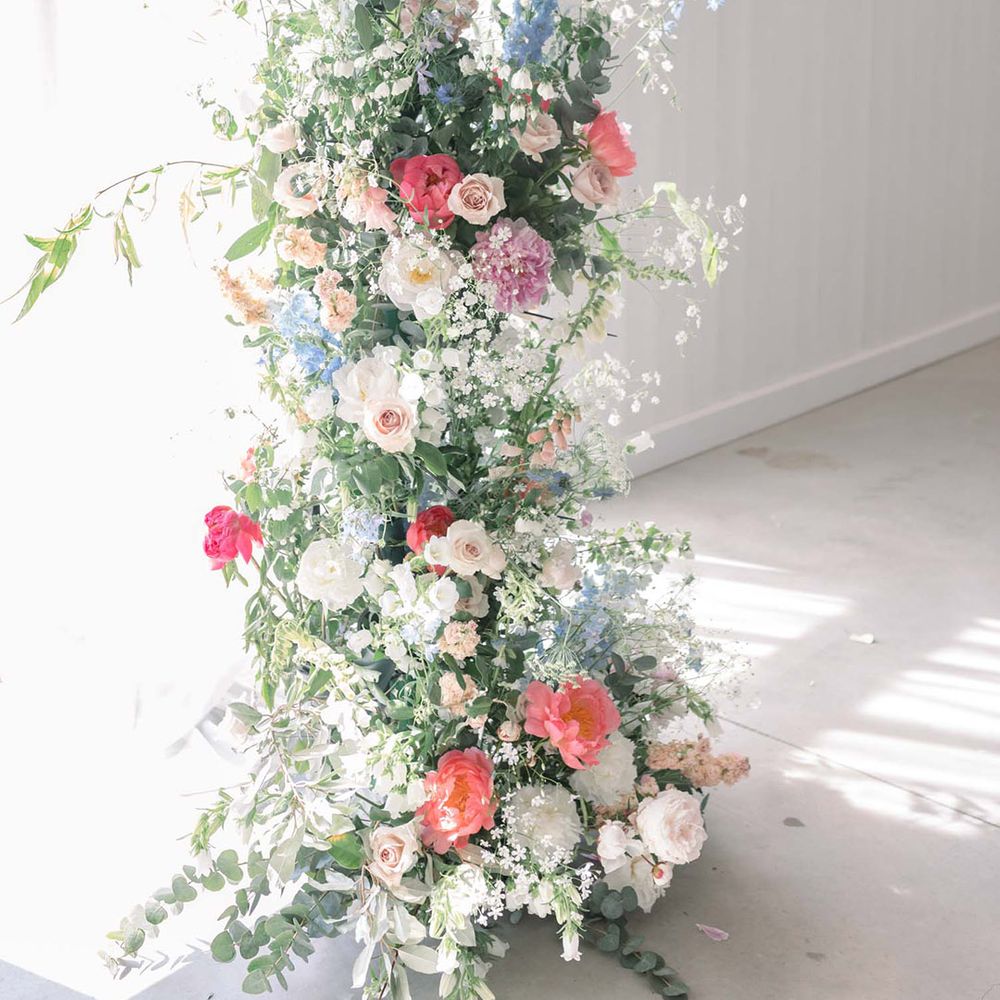 Pastel pink, blue, peach and white wedding flowers with peonies, carnations, roses and stocks 
