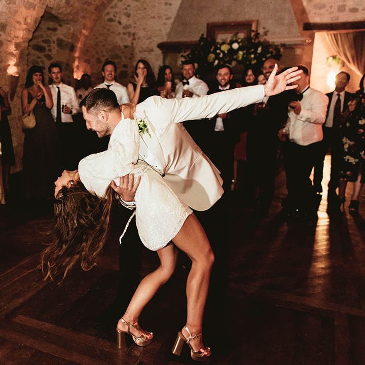 Groom dips his bride whilst dancing on their wedding day
