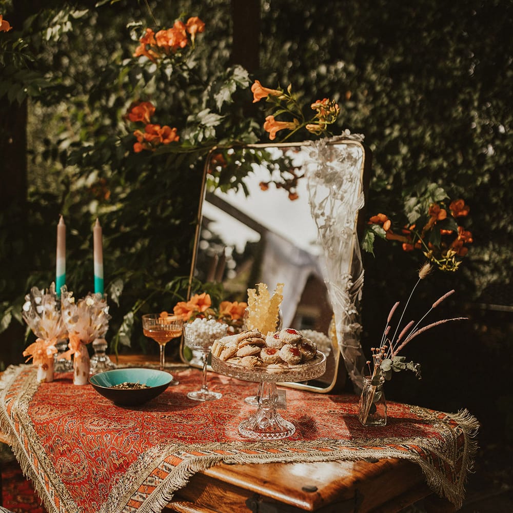Rustic dessert table complete with Moroccan styled rug across the top