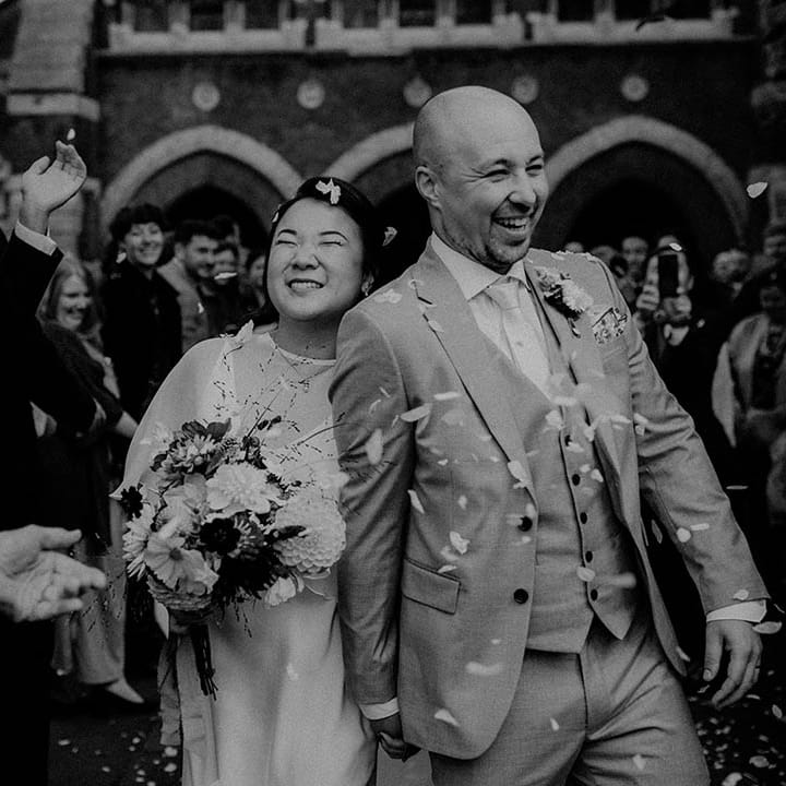 Bride & groom leave wedding ceremony as wedding guests throw confetti around them | Irene Yap Photography