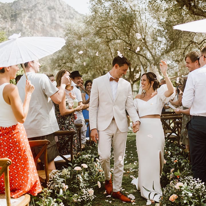Bride and groom walk down the aisle as a married couple