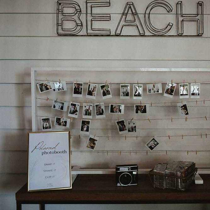 Polaroid photobooth with white frame and string to hang photo from 