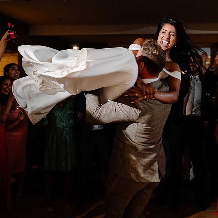 Groom spins the bride around for their first dance 