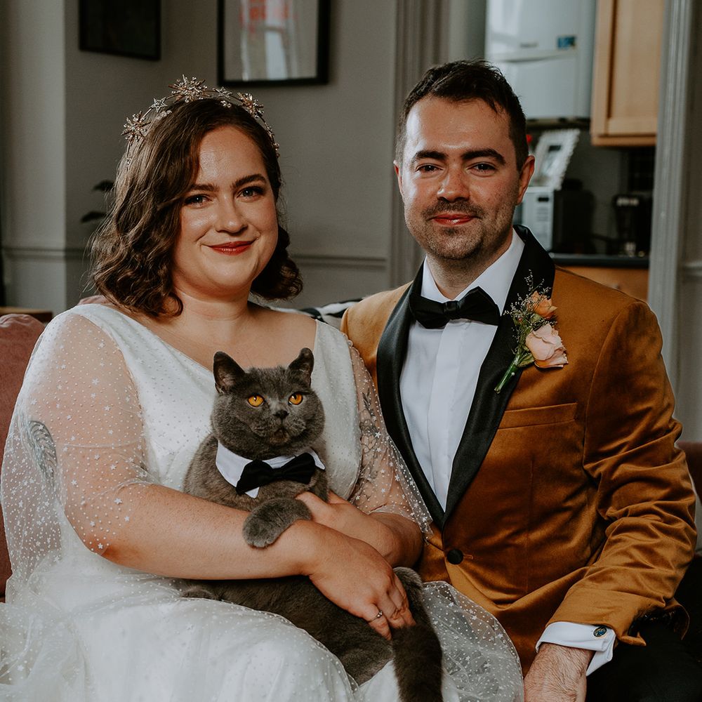 The couple take part in a family portrait with beloved pet cat Bowie. Bowie wears a collar and bow tie