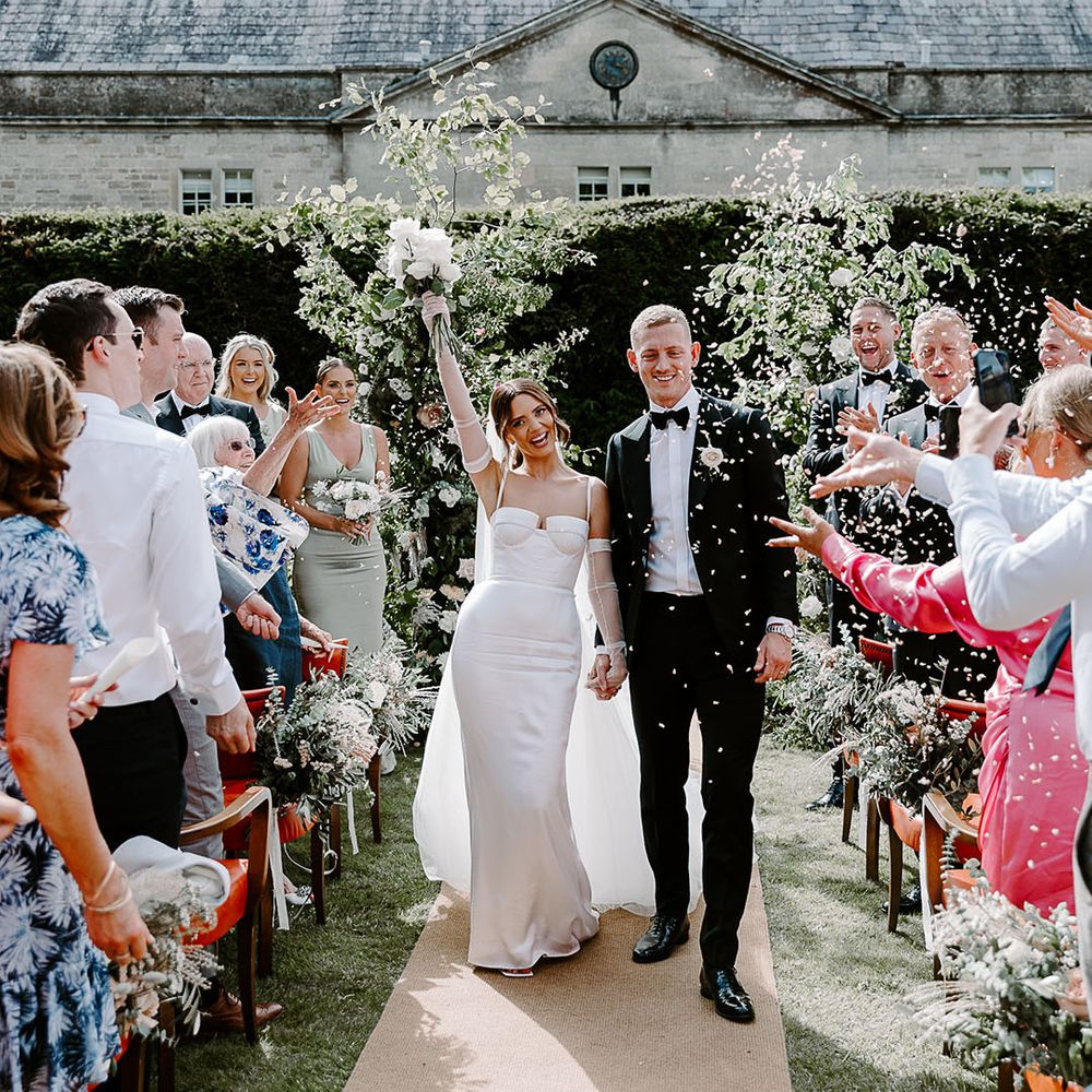 Confetti exit for couple at outdoor wedding ceremony 