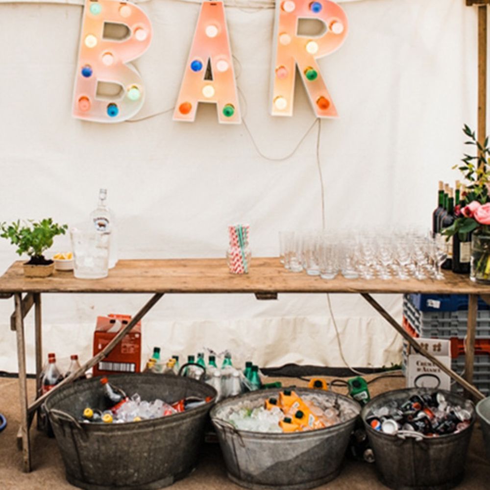 DIY wedding bar design ideas at marquee wedding reception and large sign 