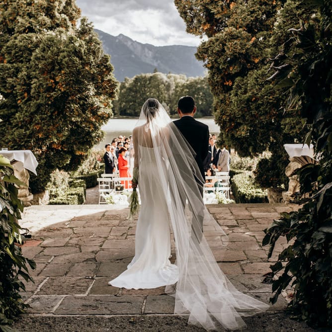 Bride about to walk down the aisle in cathedral length veil 