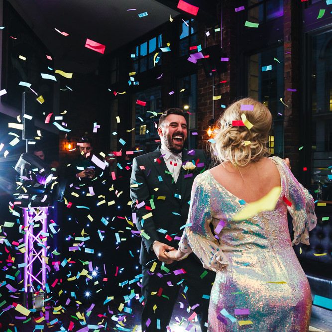 Bride & groom dance together surrounded by confetti 