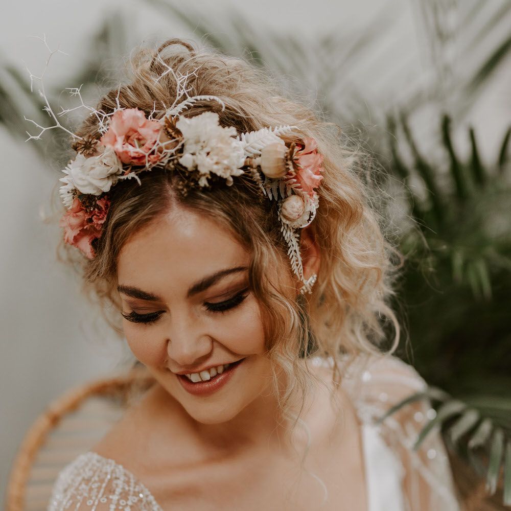 Bride wearing a tropical themed pink and white headband, with jewelled chiffon flowing short sleeved wedding dress