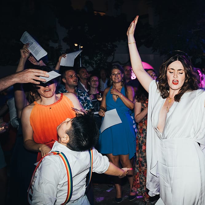 Bride wears white jumpsuit from ASOS for wedding reception