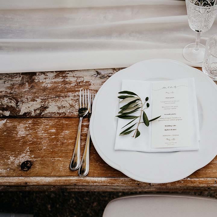 White plate complete with classic stationery and sprig of olive  | Royal Studio