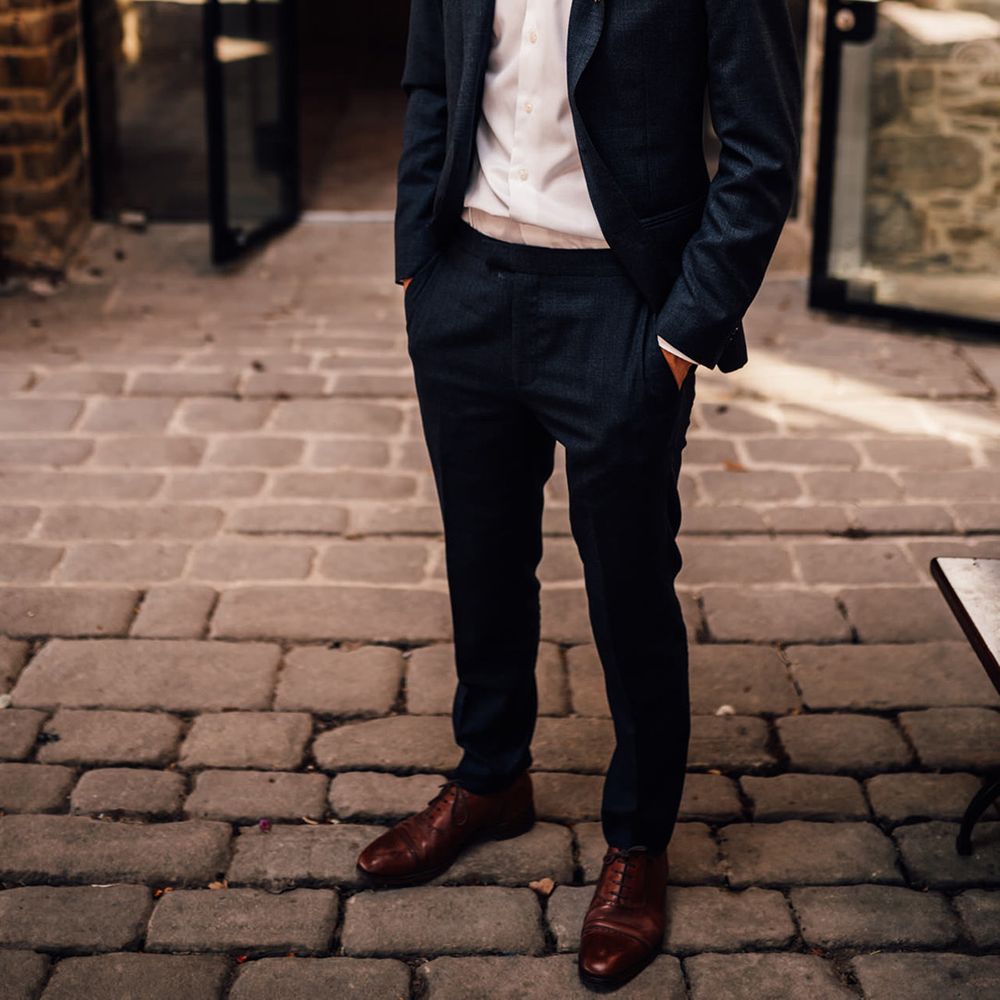 Groom stands outdoors 