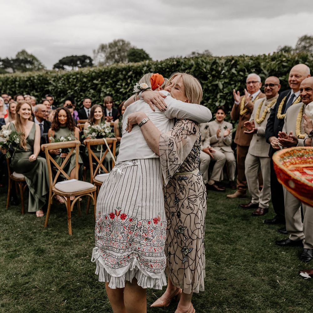 Multicultural ceremony with a Milni ritual, a joining of 2 families by swapping flower garlands