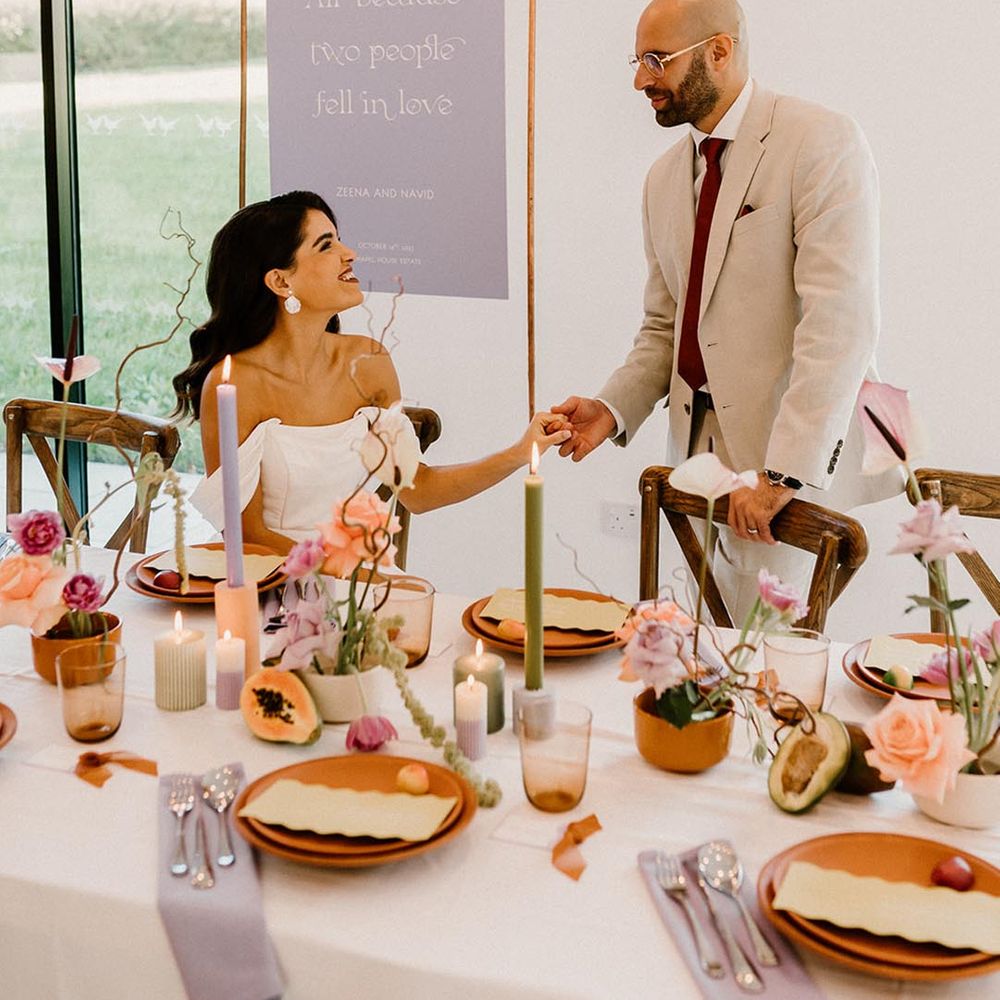 Bride and groom go to sit for their wedding reception with a lavender, rust and green colour palette 