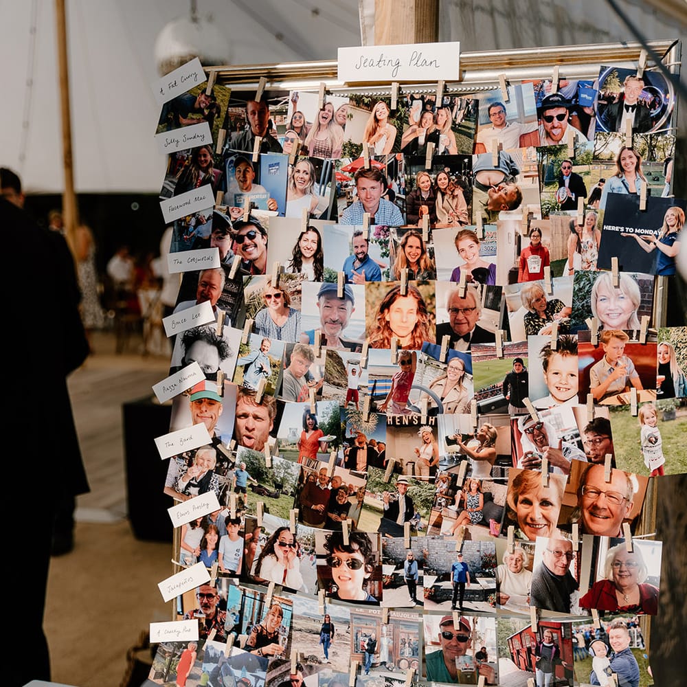 DIY seating plan complete with pictures of wedding guests and white pegs