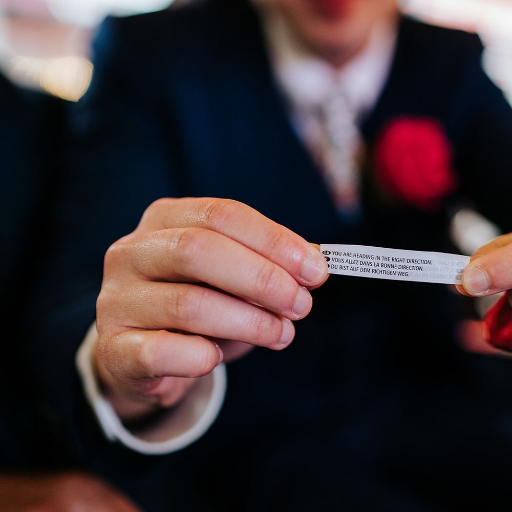 Groom holds fortune cookie fortune 