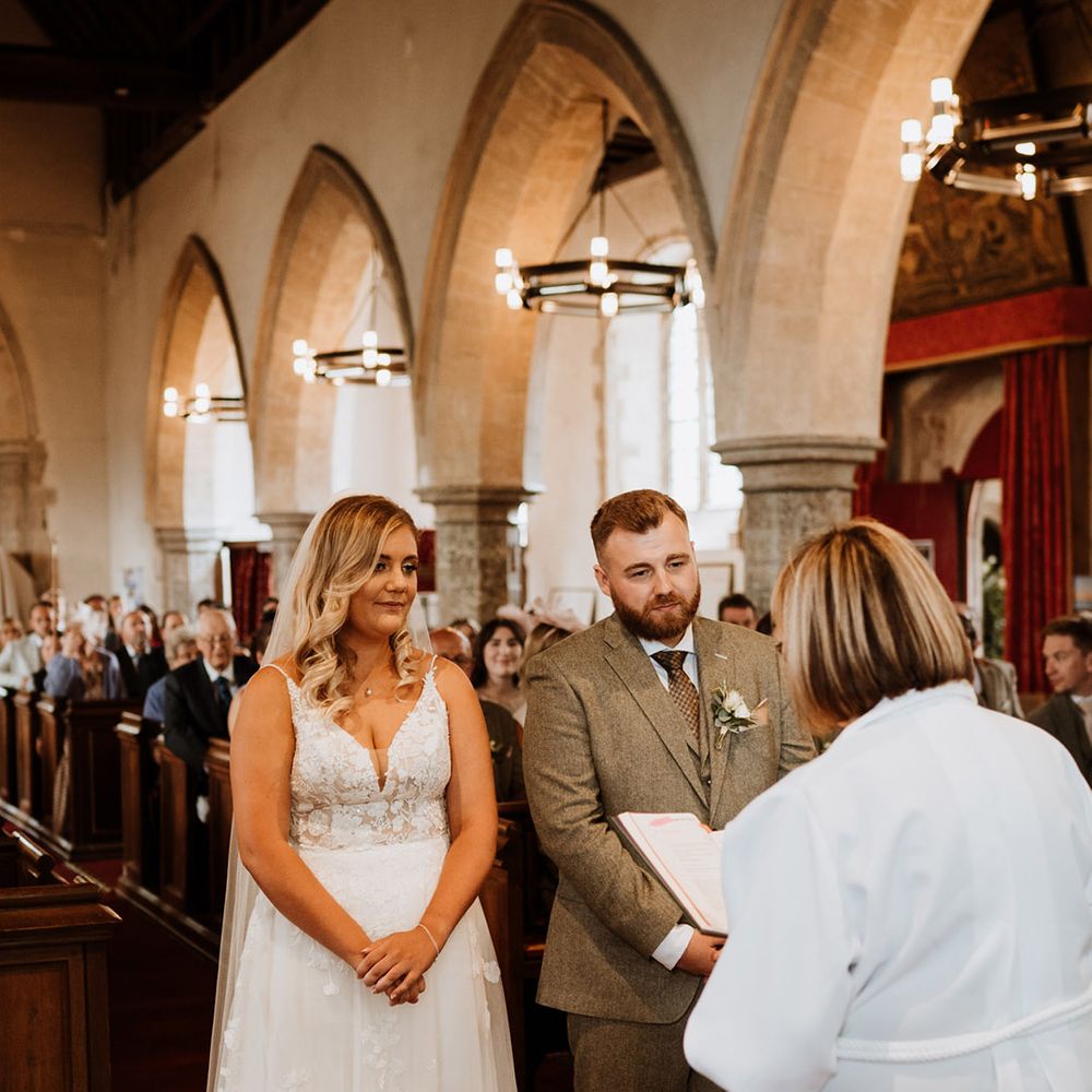 The bride and groom participate in a traditional church wedding ceremony 