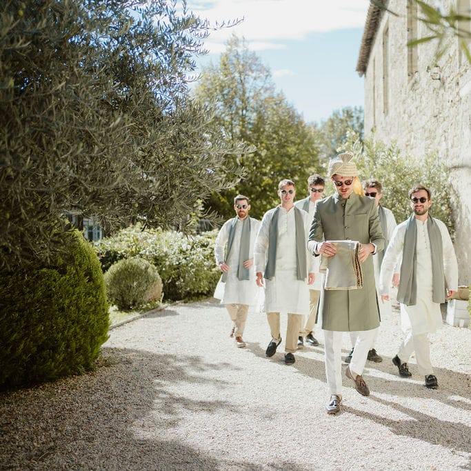 Groom and groomsmen in cream and green Sherwani and Churidar outfits at Provence wedding 