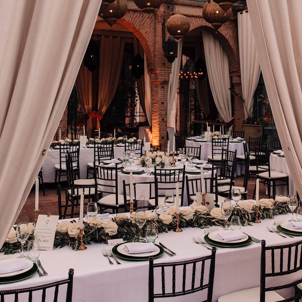 White drapery decorating the Beldi Country Club wedding venue with golden lanterns 